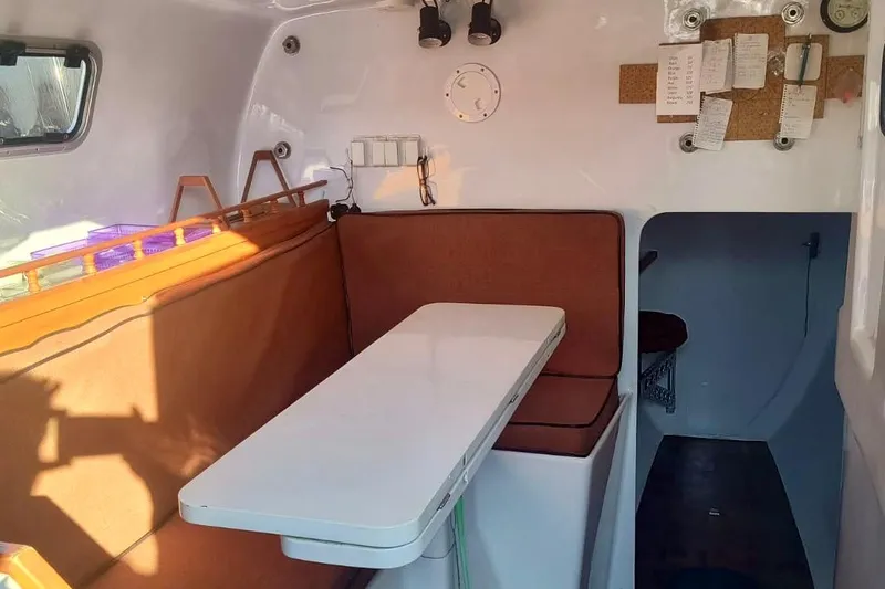 Slide: The Image of Interior of a 2012 Hughes 40 sailboat with seating and table. - 28