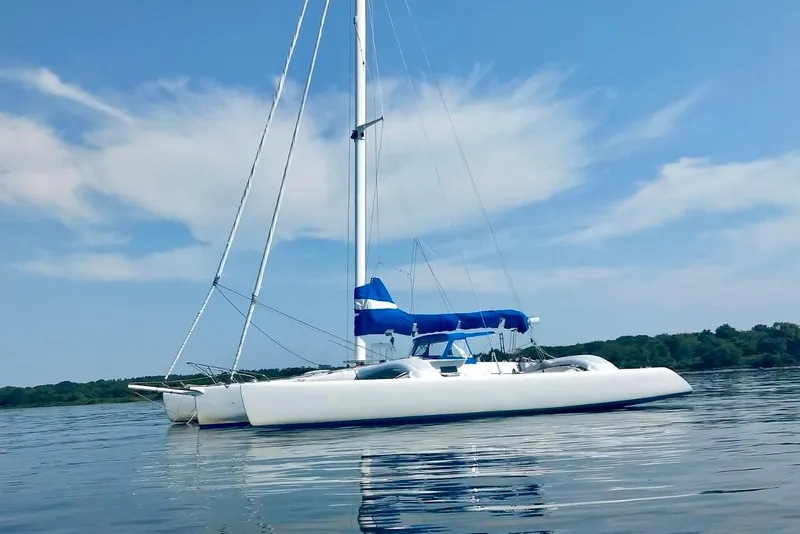Slide: The Image of Sleek 2012 Kurt Hughes 40 sailboat on calm water under blue sky. - 3