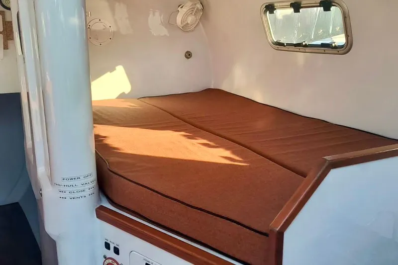 Slide: The Image of Cozy cabin interior of 2012 Hughes 40 sailboat with brown cushioned bed. - 30