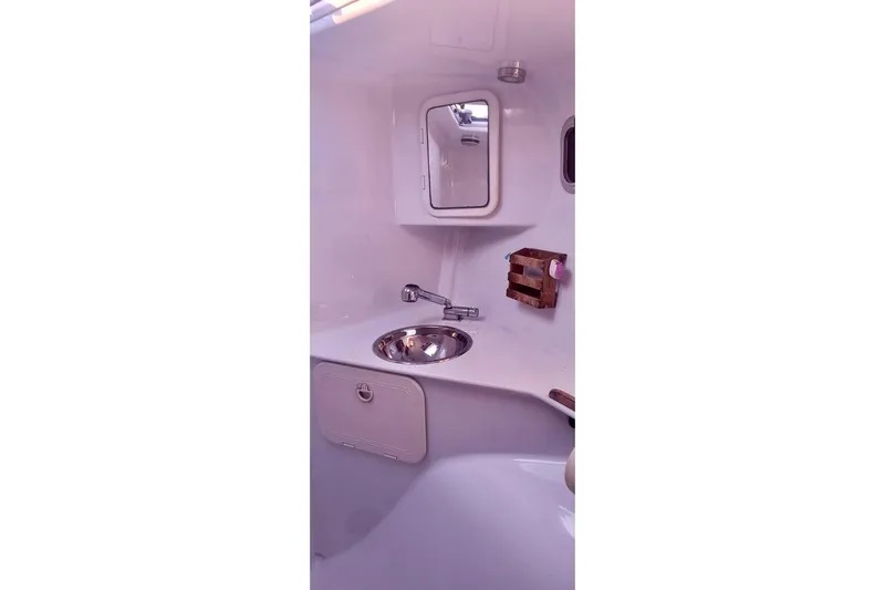 Slide: The Image of Compact bathroom interior of 2012 Hughes 40 yacht with sink and mirror. - 31