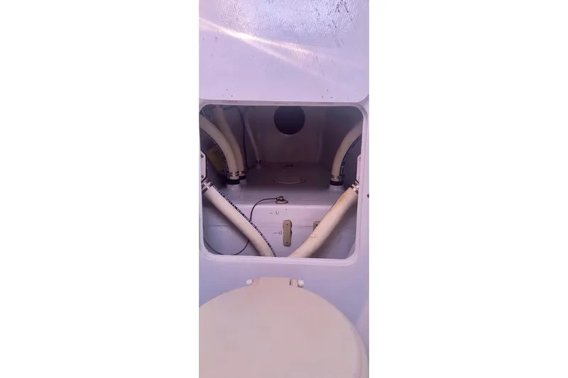 Slide: The Image of Interior view of a 2012 Hughes 40 boat showing plumbing and storage compartment. - 33