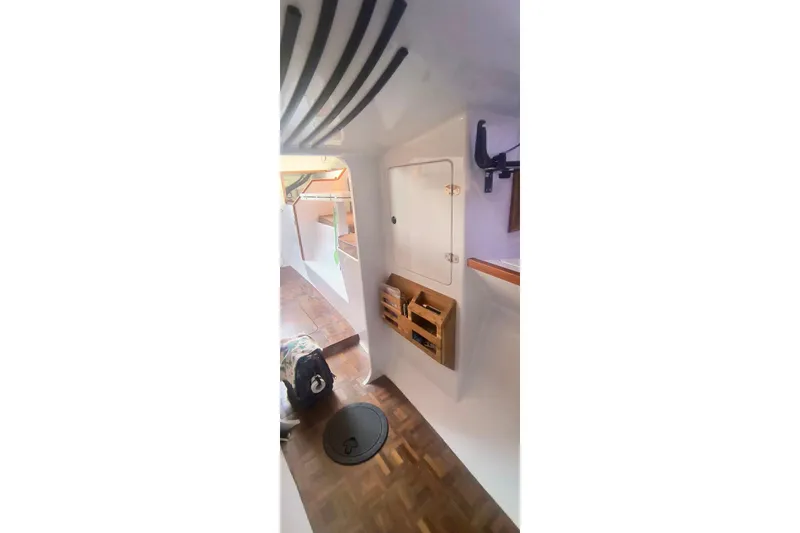 Slide: The Image of Interior of a 2012 Hughes 40 sailboat with wooden flooring and storage compartments. - 36