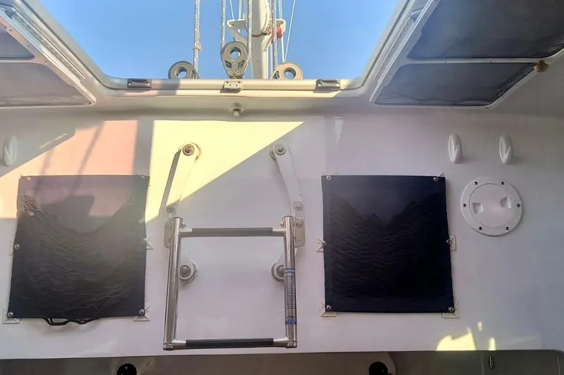 Slide: The Image of Interior view of a 2012 Hughes 40 sailboat, featuring a hatch and ladder. - 38