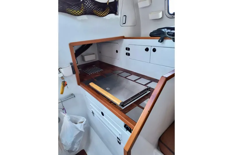 Slide: The Image of Compact interior of 2012 Kurt Hughes 40 sailboat with wooden accents and storage compartments. - 4