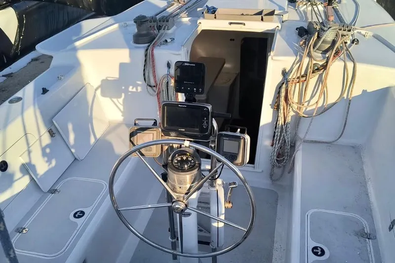 Slide: The Image of Cockpit of 2012 Hughes 40 sailboat with steering wheel and navigation equipment. - 46