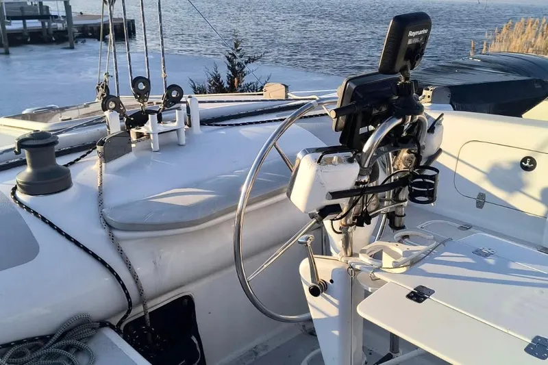 Slide: The Image of Cockpit of a 2012 Hughes 40 sailboat with steering wheel and navigation equipment. - 47