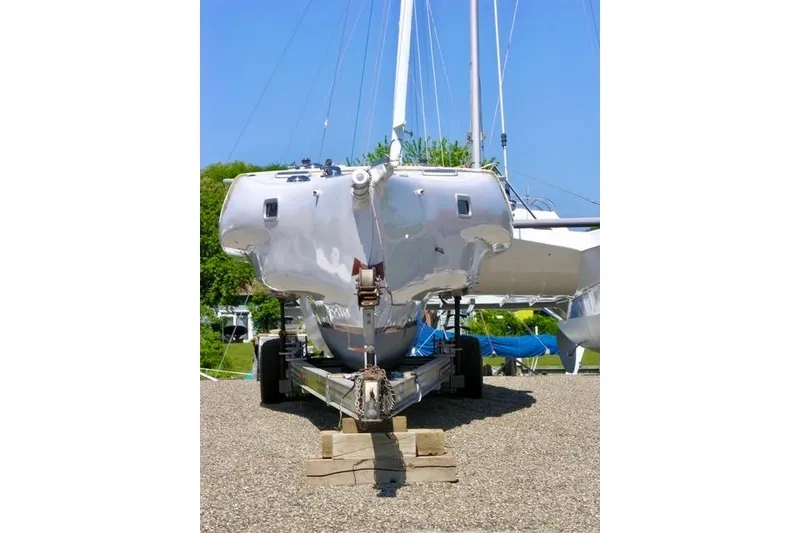 Slide: The Image of Hughes 40 sailboat from 2012 on a trailer, displayed outdoors under a clear blue sky. - 8