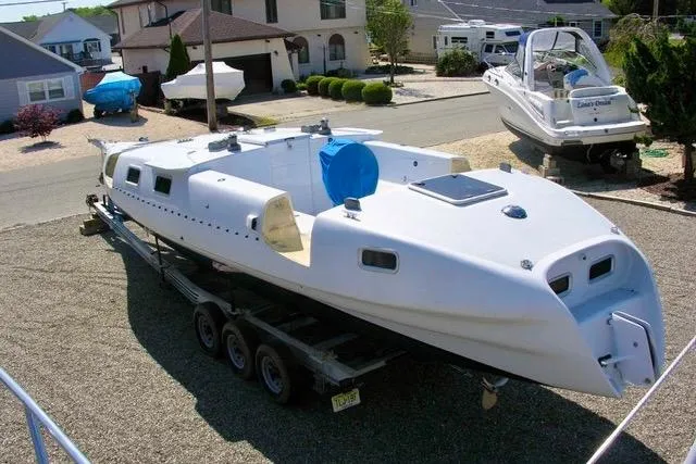 Slide: The Image of White Hughes 40 sailboat on trailer, residential area, 2012 model. - 9