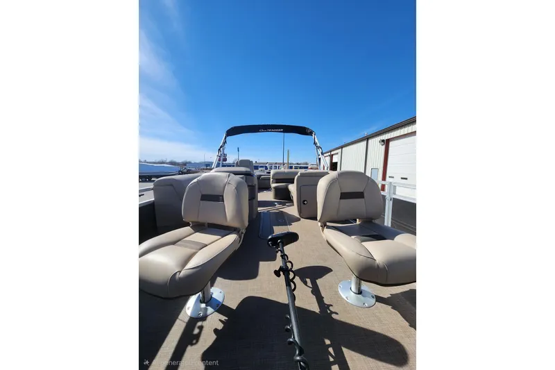 Slide: The Image of 2024 Sun Tracker Fishin' Barge 22 XP3 with comfortable seating and clear blue sky backdrop. - 5
