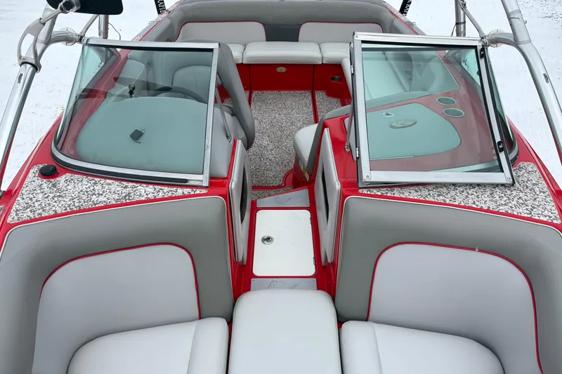 Slide: The Image of 2006 Centurion Enzo SV230 boat interior with red and gray seating, open windshield. - 11