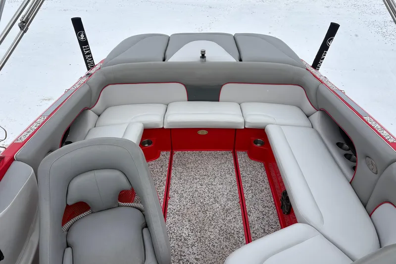 Slide: The Image of 2006 Centurion Enzo SV230 boat interior with gray and red seating, spacious layout. - 12