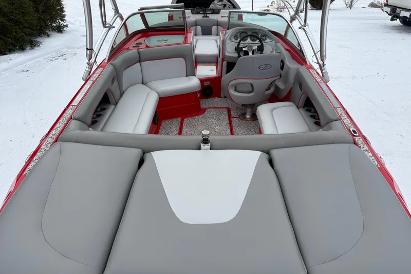 Slide: The Image of 2006 Centurion Enzo SV230 boat interior with red and gray seating, snowy background. - 5