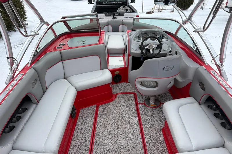 Slide: The Image of 2006 Centurion Enzo SV230 boat interior with red and gray seating, steering wheel, and dashboard. - 6