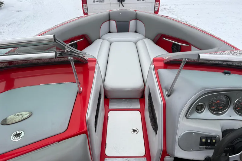 Slide: The Image of 2006 Centurion Enzo SV230 boat interior with red and gray seating and dashboard. - 8