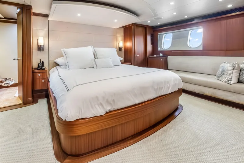 Slide: The Image of Luxurious interior of 2012 Cheoy Lee 84 Bravo yacht, featuring elegant wood staircase and cozy bedroom. - 29