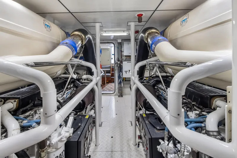 Slide: The Image of Engine room of 2012 Cheoy Lee 84 Bravo yacht, featuring large exhaust pipes and control panels. - 51