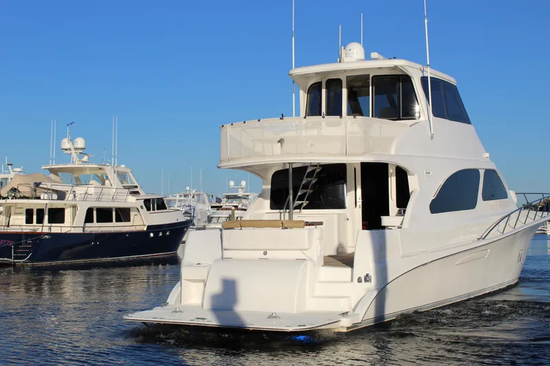 Slide: The Image of 2003 Ocean Yachts 65 Odyssey in marina, showcasing sleek design and spacious deck. - 10