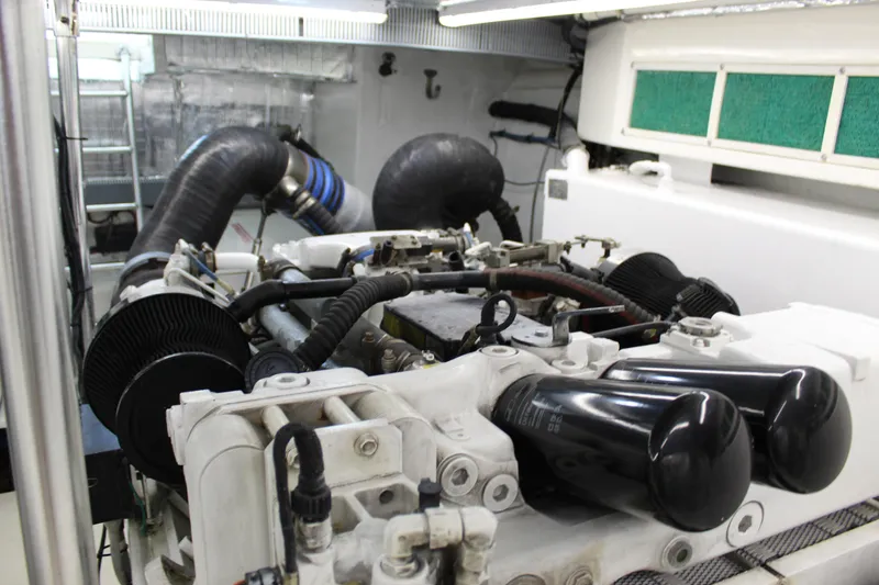 Slide: The Image of Engine room of 2003 Ocean Yachts 65 Odyssey, showcasing mechanical components and piping. - 100