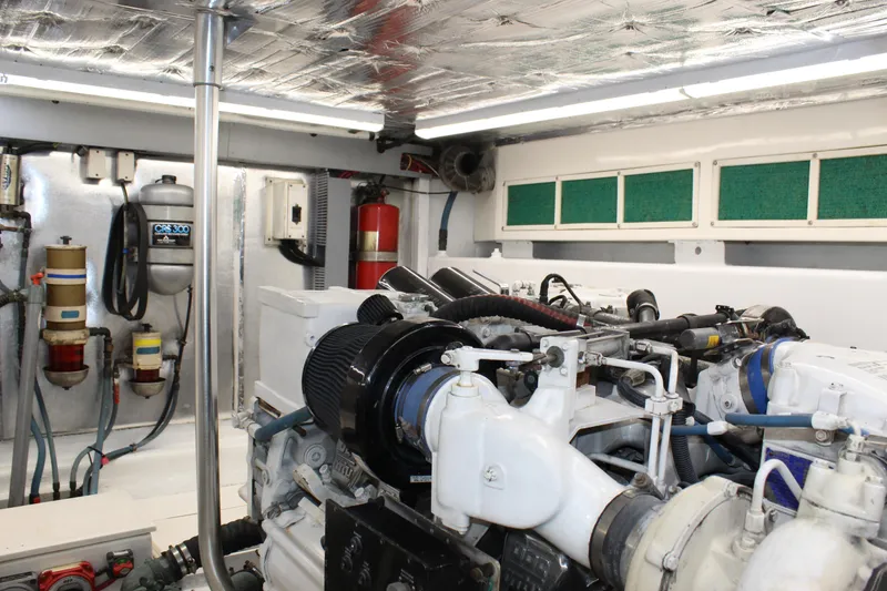 Slide: The Image of Engine room of 2003 Ocean Yachts 65 Odyssey, featuring mechanical components and equipment. - 104