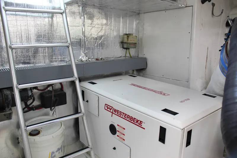 Slide: The Image of Engine room of 2003 Ocean Yachts 65 Odyssey with Westerbeke generator and ladder. - 111
