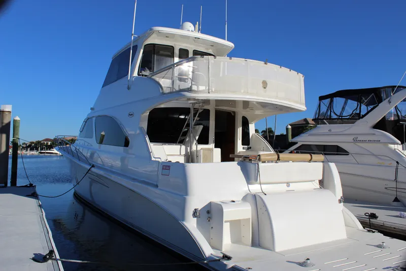 Slide: The Image of 2003 Ocean Yachts 65 Odyssey docked at marina under clear blue sky. - 12