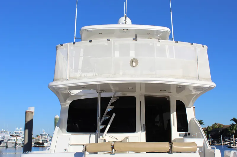 Slide: The Image of 2003 Ocean Yachts 65 Odyssey yacht, rear view, docked under clear blue sky. - 15