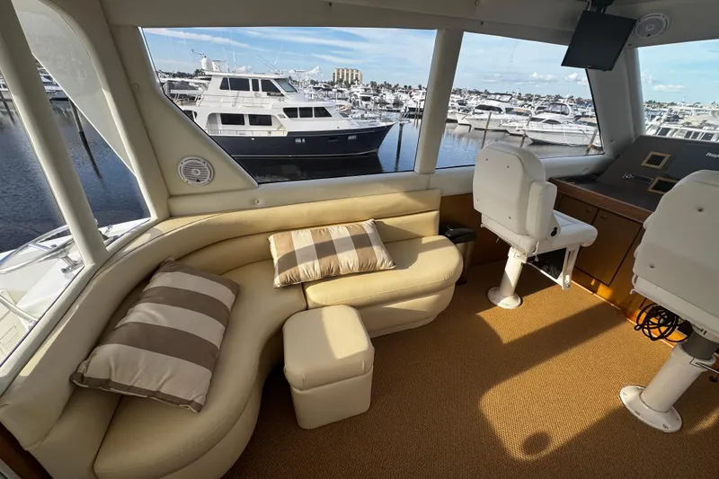 Slide: The Image of 2003 Ocean Yachts 65 Odyssey docked at marina with colorful buildings in background. - 21