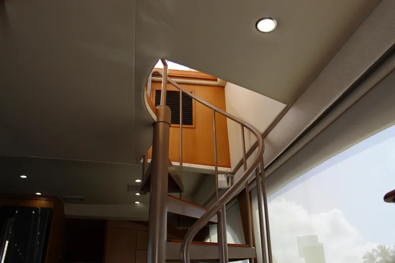 Slide: The Image of Interior view of 2003 Ocean Yachts 65 Odyssey with spiral staircase and modern lighting. - 42