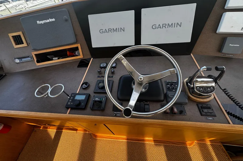 Slide: The Image of Helm of 2003 Ocean Yachts 65 Odyssey with Garmin and Raymarine navigation systems. - 44