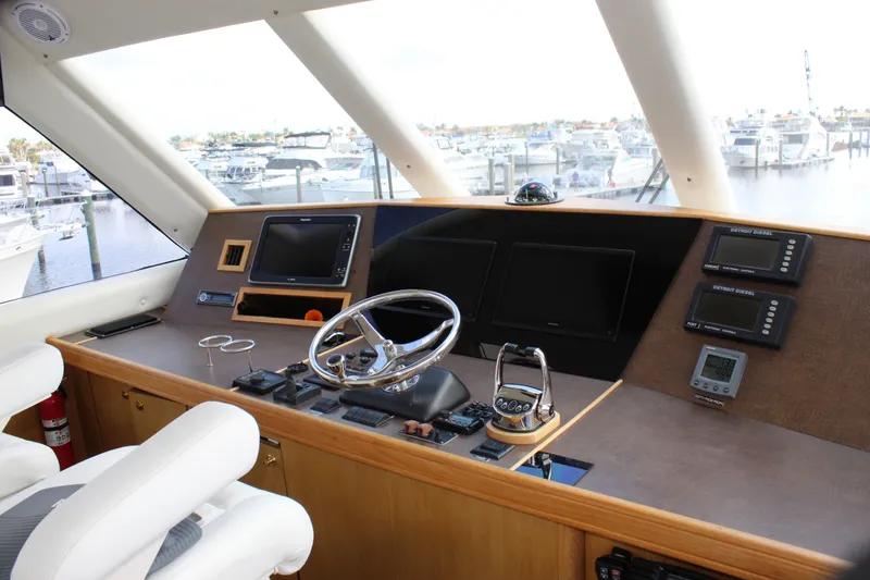 Slide: The Image of Helm of 2003 Ocean Yachts 65 Odyssey with modern navigation equipment and marina view. - 46
