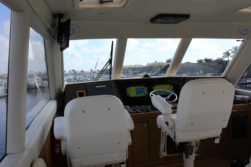 Slide: The Image of Interior helm of 2003 Ocean Yachts 65 Odyssey with navigation equipment and dual captain chairs. - 47