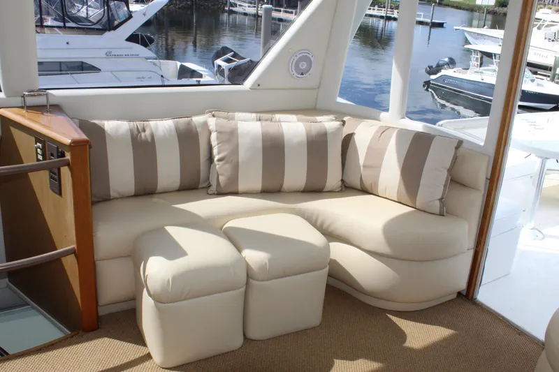 Slide: The Image of Luxurious seating area on a 2003 Ocean Yachts 65 Odyssey, featuring striped cushions. - 50