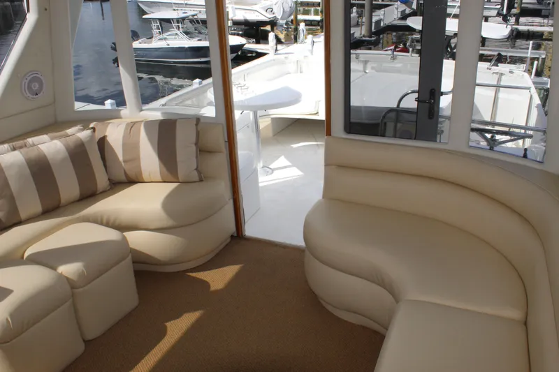 Slide: The Image of Luxurious interior of 2003 Ocean Yachts 65 Odyssey with plush seating and marina view. - 52