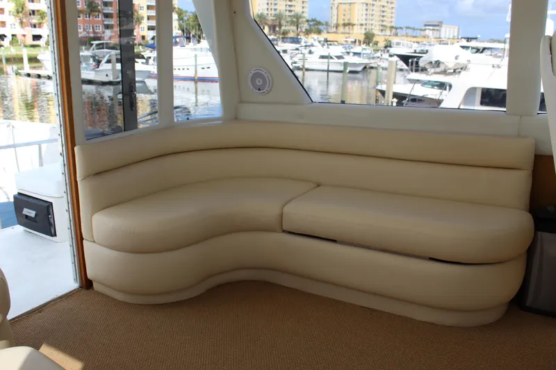 Slide: The Image of Luxurious interior seating on a 2003 Ocean Yachts 65 Odyssey, docked at a marina. - 53
