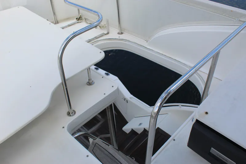Slide: The Image of Staircase on 2003 Ocean Yachts 65 Odyssey, featuring sleek metal railings and white deck. - 61