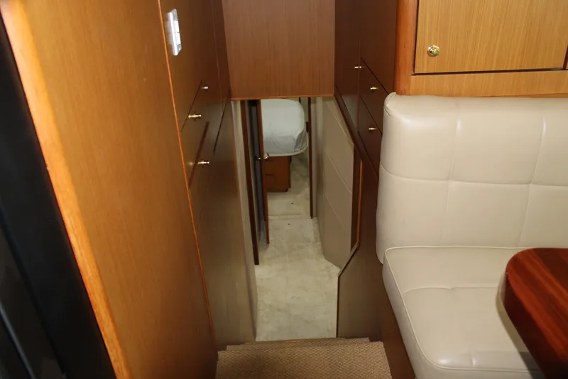 Slide: The Image of Interior view of 2003 Ocean Yachts 65 Odyssey, featuring wood cabinetry and beige seating. - 63