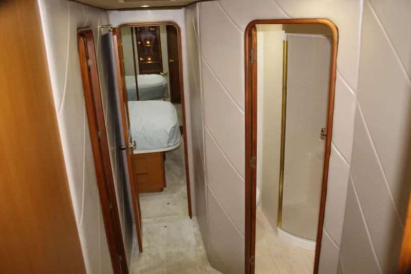 Slide: The Image of Interior hallway of 2003 Ocean Yachts 65 Odyssey, featuring bedroom and bathroom access. - 64
