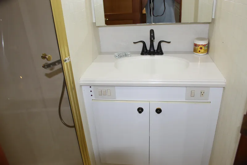 Slide: The Image of Bathroom vanity with sink and mirror in 2003 Ocean Yachts 65 Odyssey. - 65