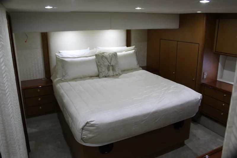 Slide: The Image of Luxurious bedroom interior of 2003 Ocean Yachts 65 Odyssey with elegant wood cabinetry. - 69