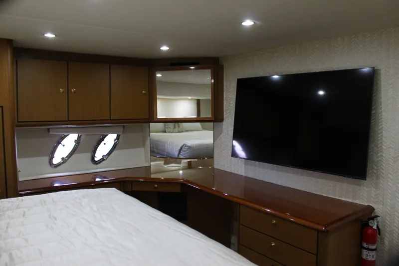 Slide: The Image of Luxurious interior of 2003 Ocean Yachts 65 Odyssey with TV and wooden cabinetry. - 71