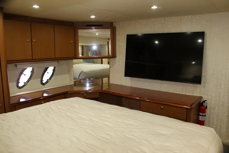 Slide: The Image of Luxurious cabin interior of 2003 Ocean Yachts 65 Odyssey with TV and portholes. - 72