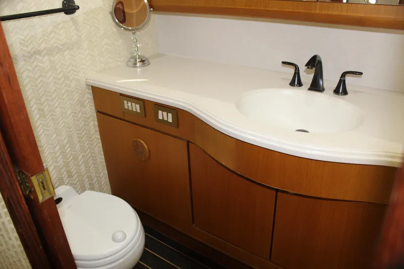 Slide: The Image of Bathroom interior of 2003 Ocean Yachts 65 Odyssey with modern sink and toilet. - 75