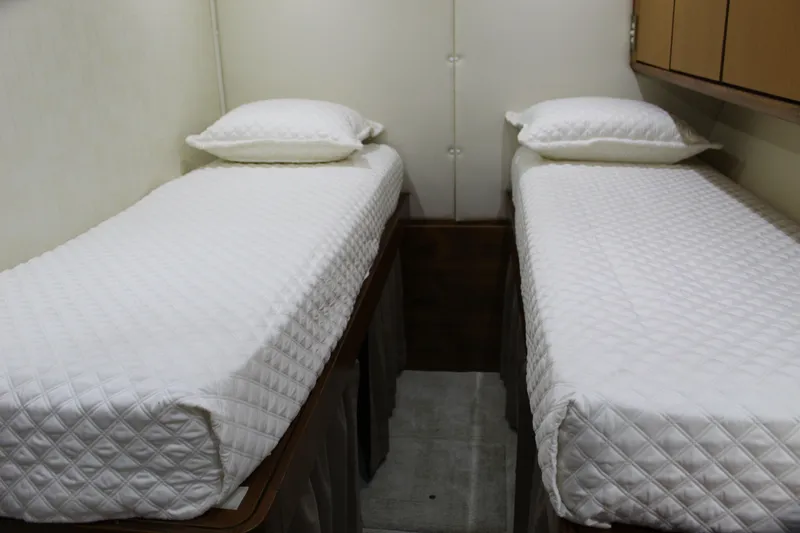 Slide: The Image of Twin beds in a 2003 Ocean Yachts 65 Odyssey cabin with white bedding. - 78