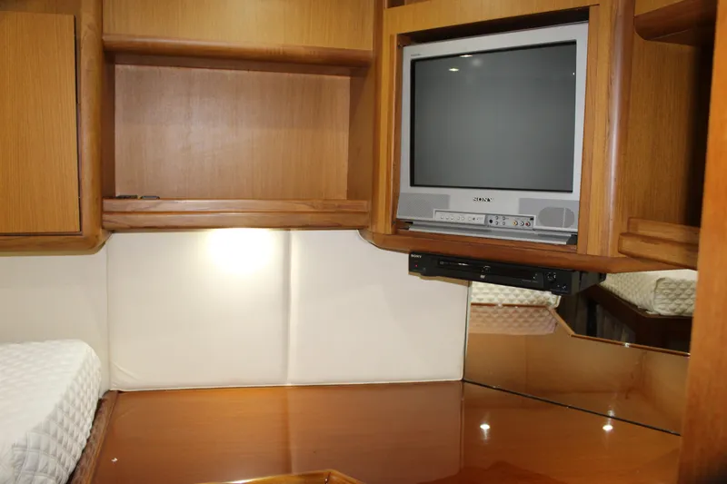 Slide: The Image of Interior of 2003 Ocean Yachts 65 Odyssey with TV and wooden cabinetry. - 79