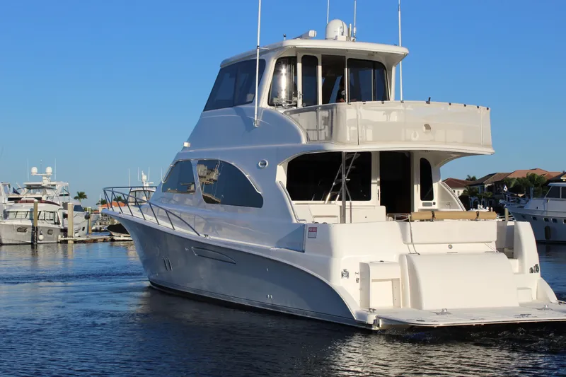 Slide: The Image of 2003 Ocean Yachts 65 Odyssey cruising in a marina under clear blue skies. - 8