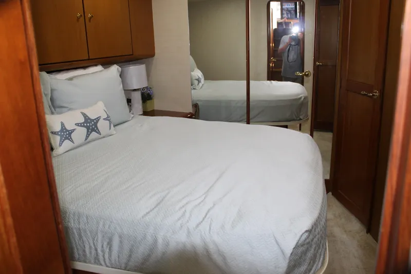 Slide: The Image of Cozy bedroom in 2003 Ocean Yachts 65 Odyssey with starfish-themed decor. - 82