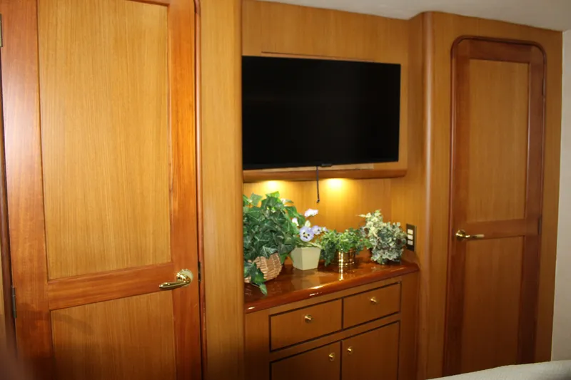 Slide: The Image of Luxurious interior of 2003 Ocean Yachts 65 Odyssey with wood paneling and TV. - 84