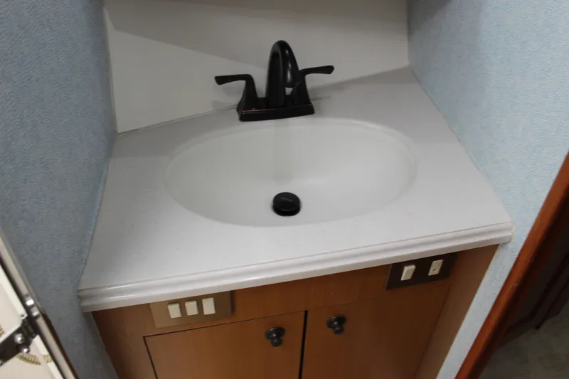 Slide: The Image of Bathroom sink with black faucet in 2003 Ocean Yachts 65 Odyssey. - 85