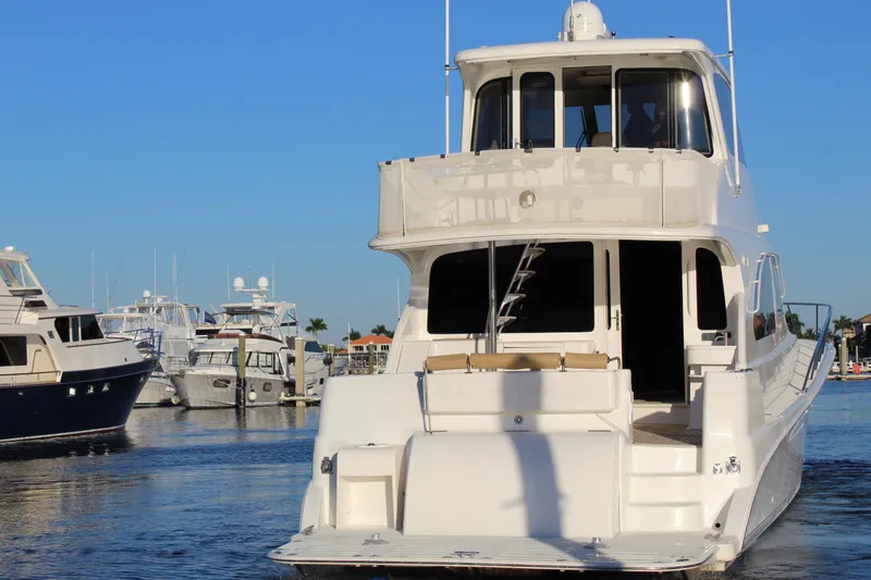 Slide: The Image of 2003 Ocean Yachts 65 Odyssey docked in a marina under clear blue skies. - 9