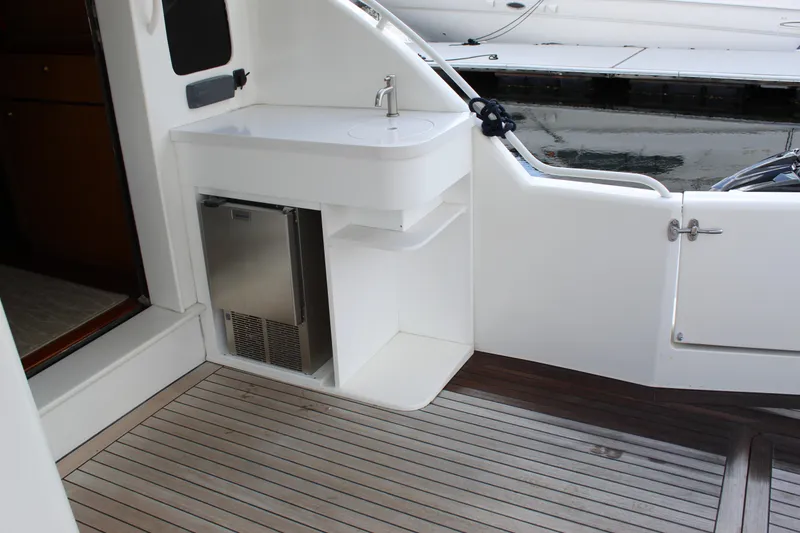 Slide: The Image of 2003 Ocean Yachts 65 Odyssey yacht deck with sink and mini fridge. - 93